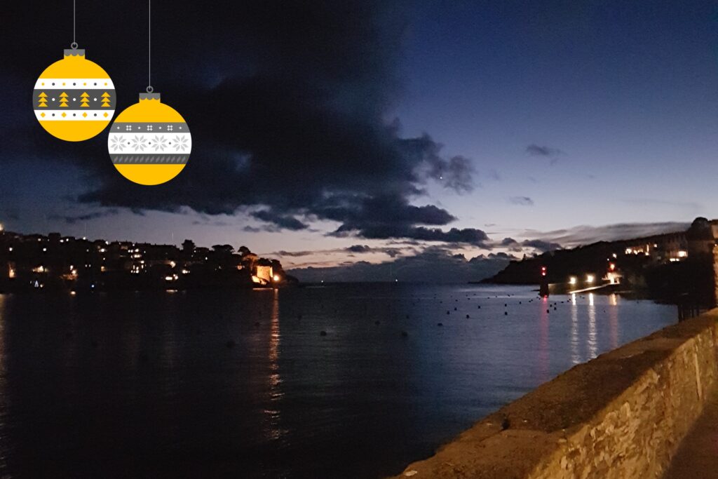 Evening on the river with reflected lights and Christmas baubles